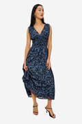 Woman wearing a blue floral dress on a white background
