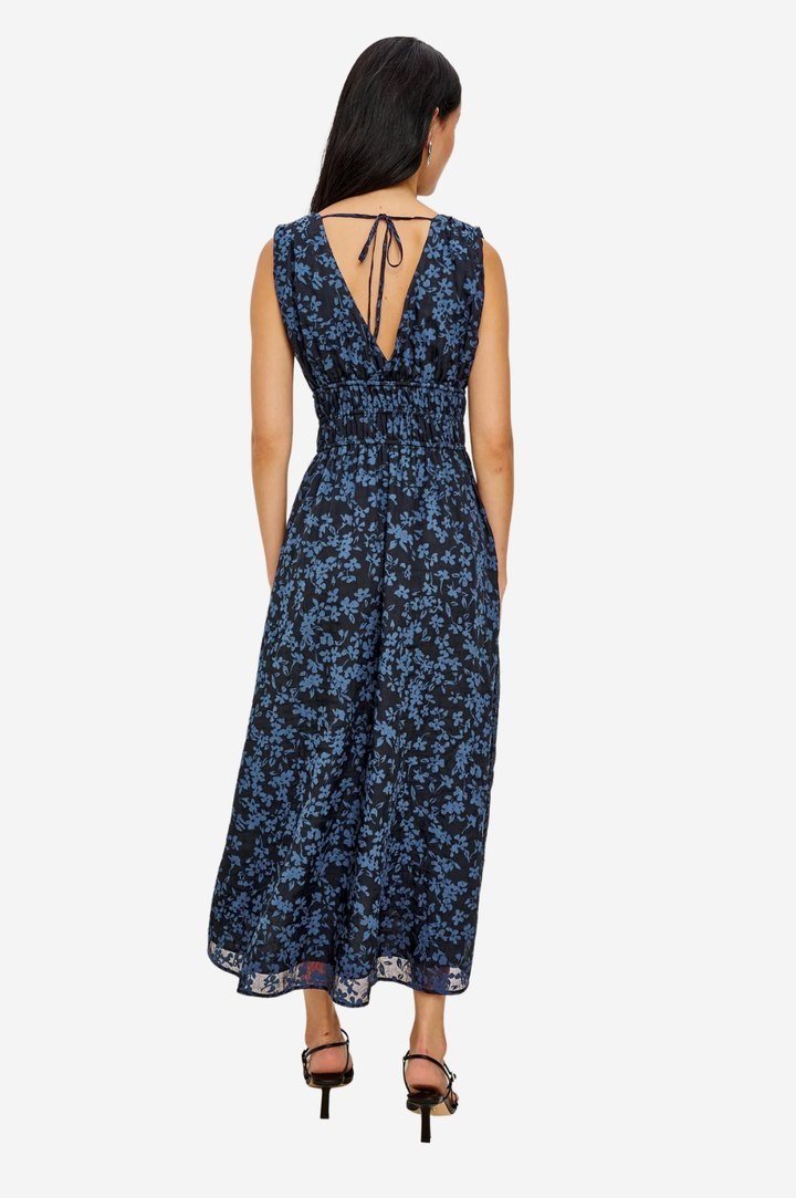 Woman wearing a blue floral dress on a white background