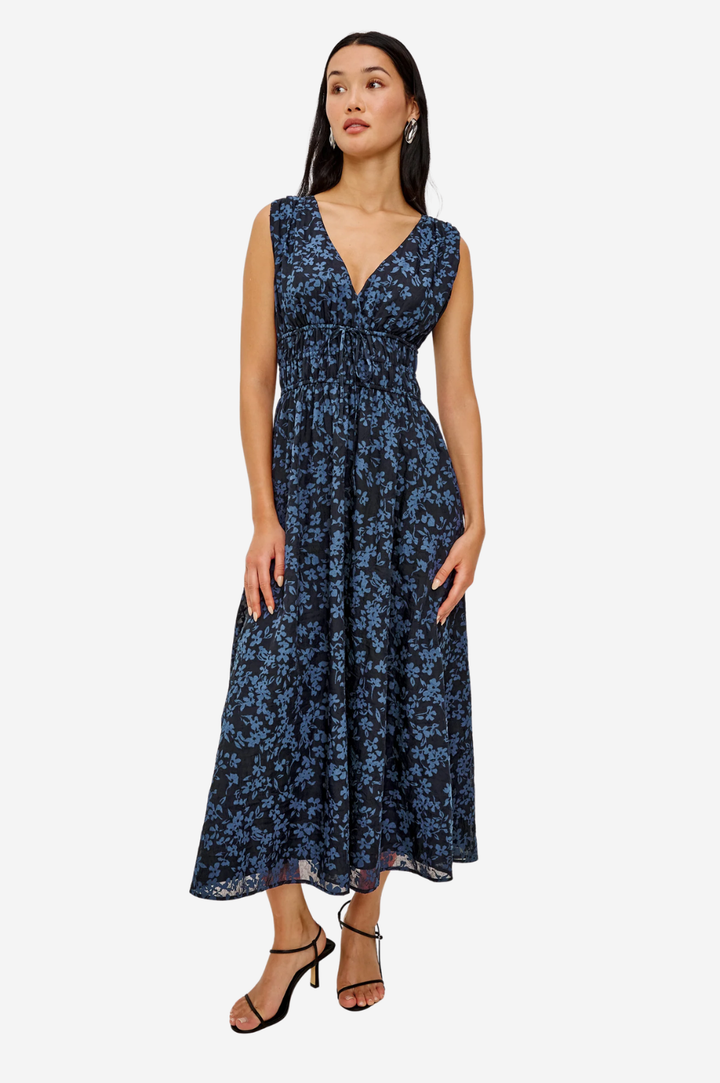 Woman wearing a blue floral dress on a white background