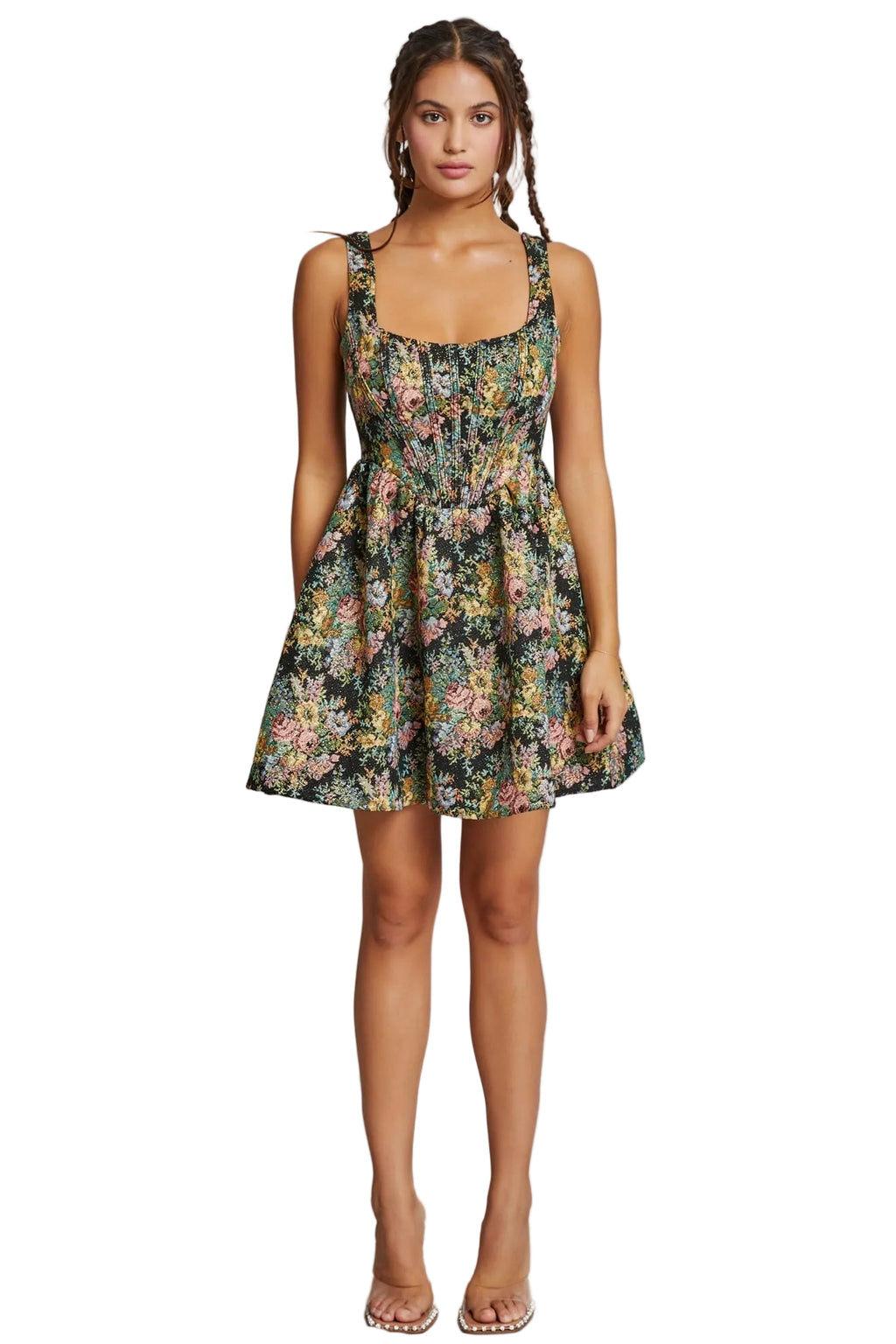Woman wearing a floral dress against a plain background