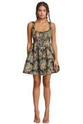 Woman wearing a floral dress against a plain background