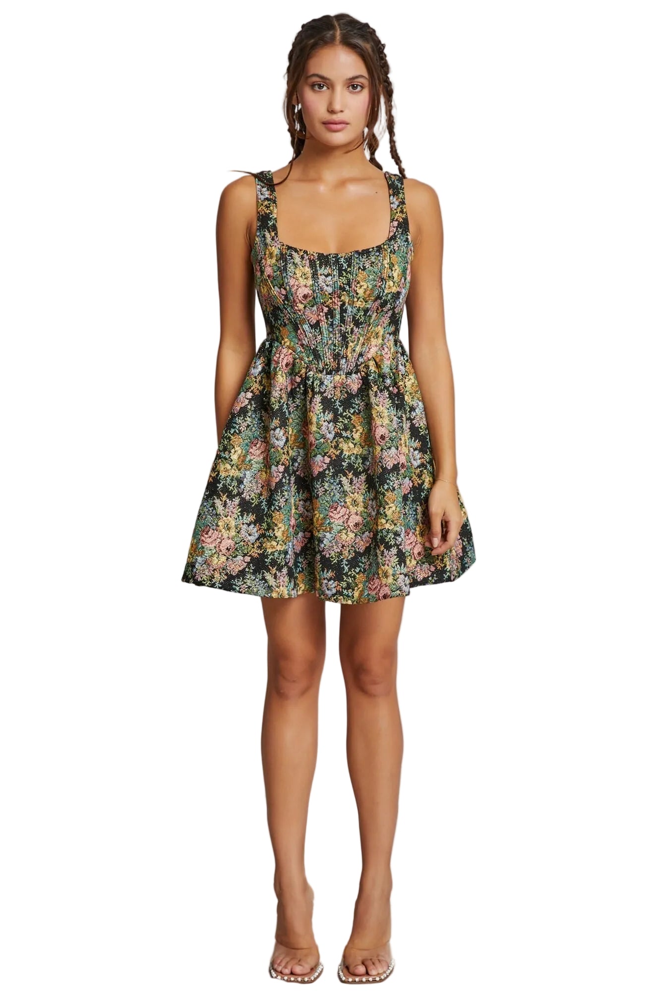 Woman wearing a floral dress against a plain background