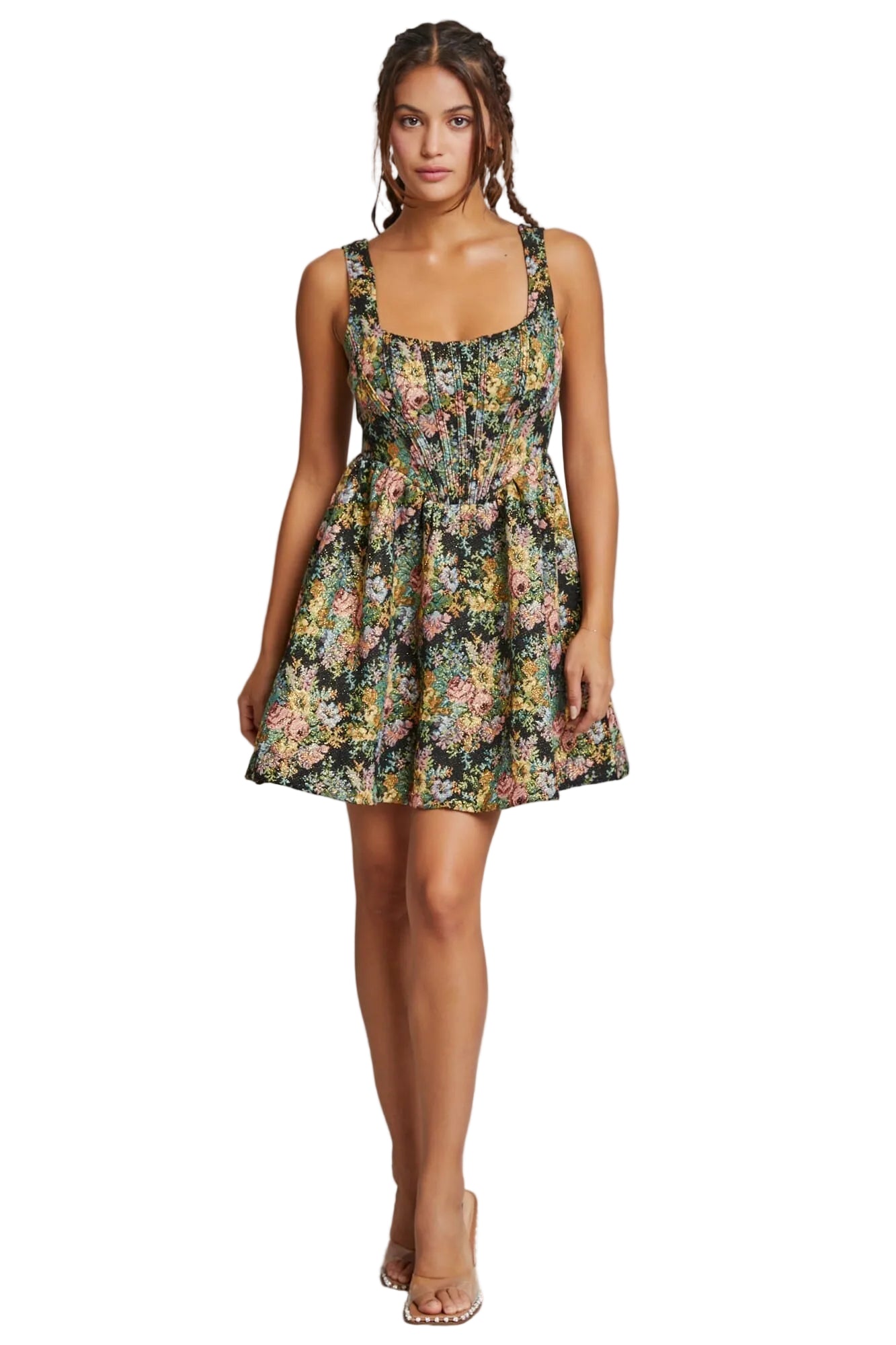 Woman wearing a floral dress against a plain background