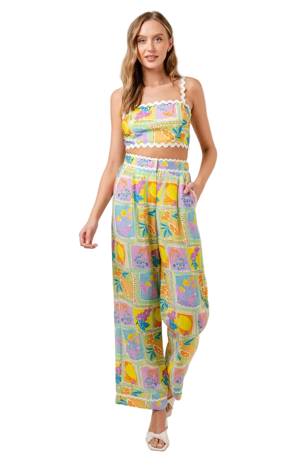 Woman wearing a colorful patterned jumpsuit on a plain background