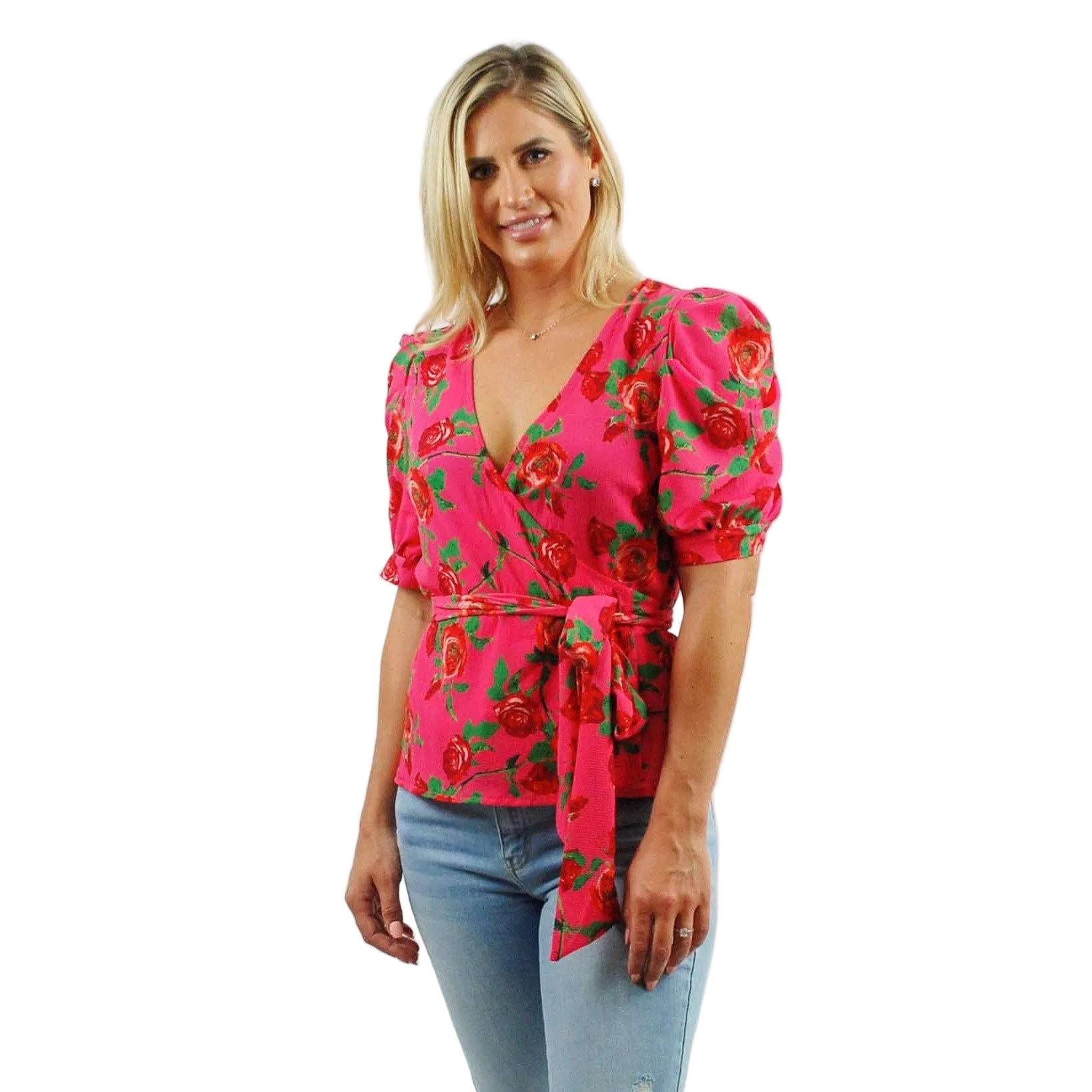 Woman wearing a pink floral blouse with puff sleeves on a white background