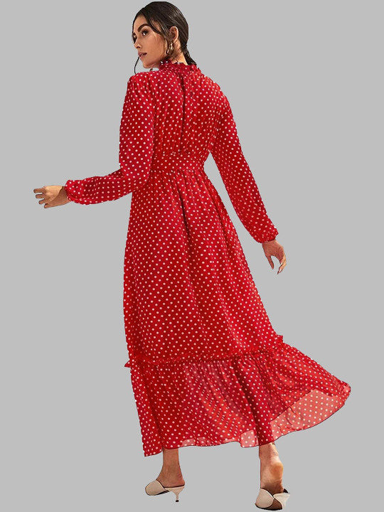 A woman modeling a long-sleeve red midi dress with a white polka dot pattern, shown from a three-quarters back angle against a solid gray background.