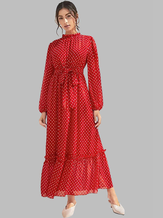 A woman modeling a long-sleeve red midi dress with a white polka dot pattern, a high ruffled collar, and a matching waist tie, set against a solid gray background.
