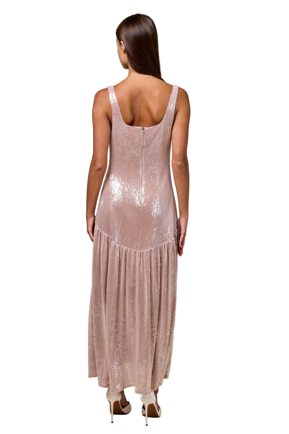 Woman wearing a sparkly pink dress against a beige background