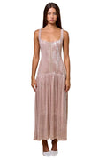 Woman wearing a pink sequin dress against a beige background