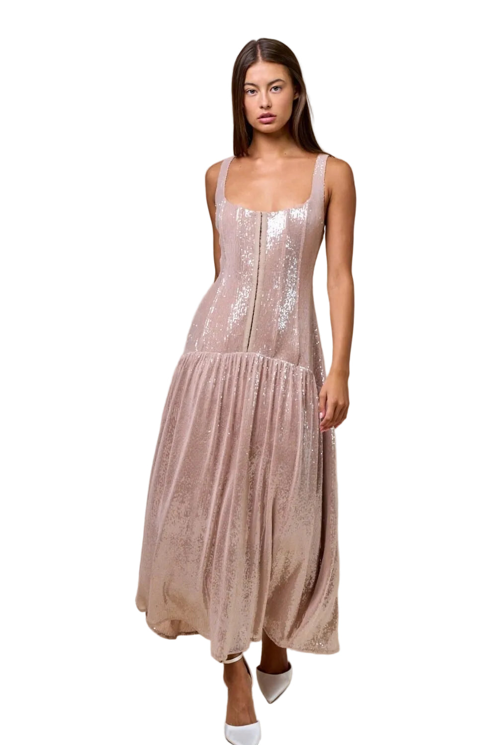 Woman wearing a sparkly dress against a beige background